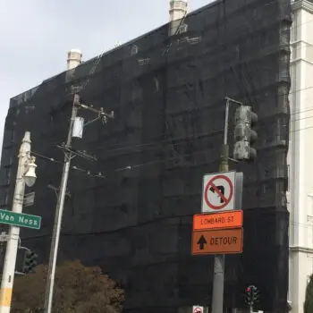 Building covered with black netting