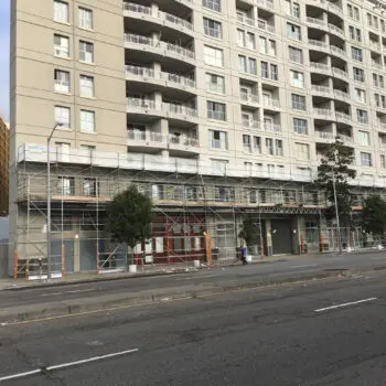 Building with scaffolding and trees