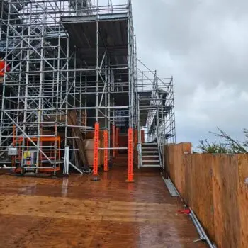 Construction scaffolding under cloudy sky