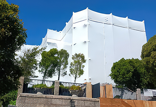 Building covered in protective sheeting