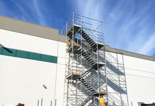 Construction scaffolding against building exterior